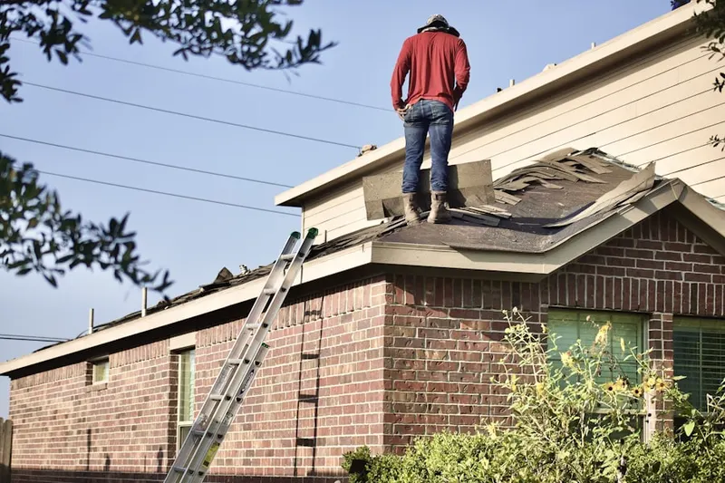 Professional roofer working on a residential roof in Hutchison